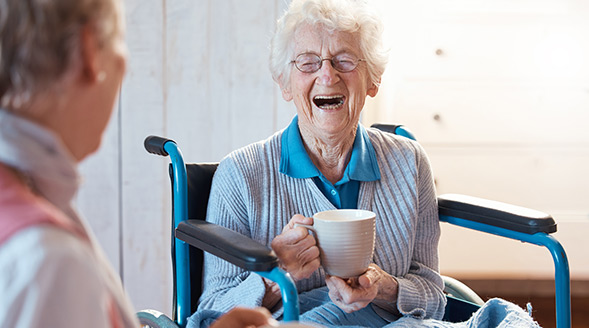 Laughing elderly woman in wheelchair