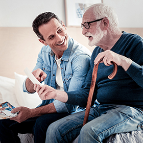 Senior man with cane talking with carer